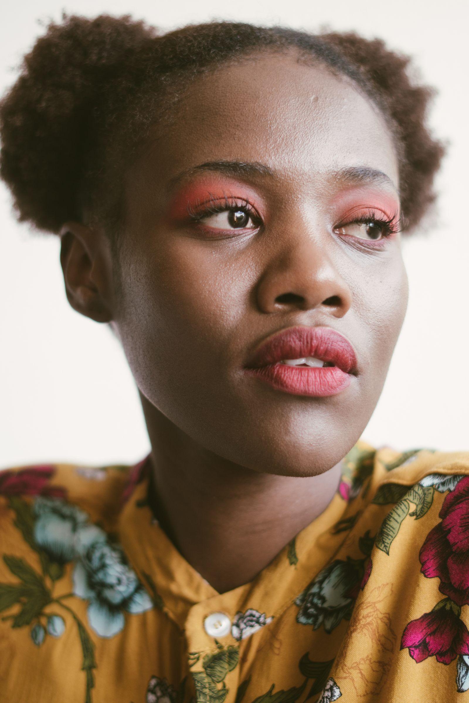 Black woman wearing the floral Sade print blouse